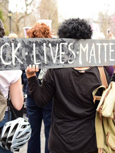 Protestors hold “Black Lives Matter” sign over their shoulders at a rally in Union Square before marching to Lower Manhattan.