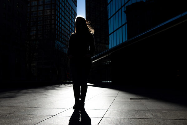 Silhouette of Farah, one of the woman in this blog, standing in front of skyscrapers