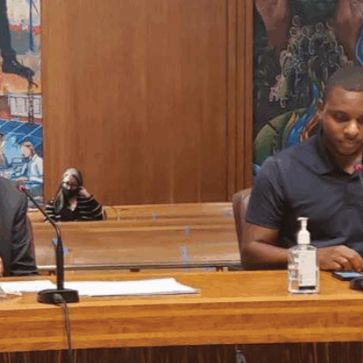 Elizer Darris testifies at a hearing while Ramsey County Attorney John Choi observes.