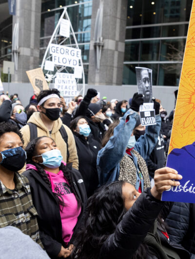Protestors holding up a portrait of George Floyd