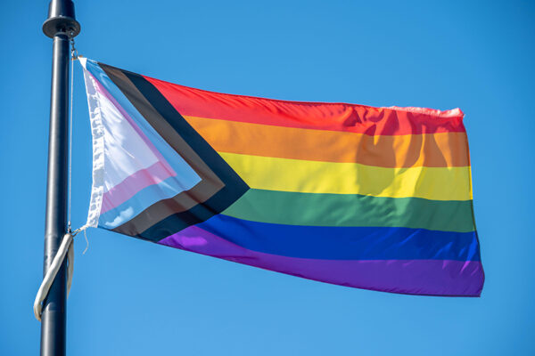 Image of inclusive Pride flag flowing in the wind