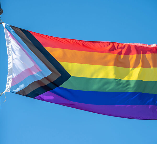 Image of inclusive Pride flag flowing in the wind