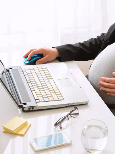 Pregnant woman working at the office