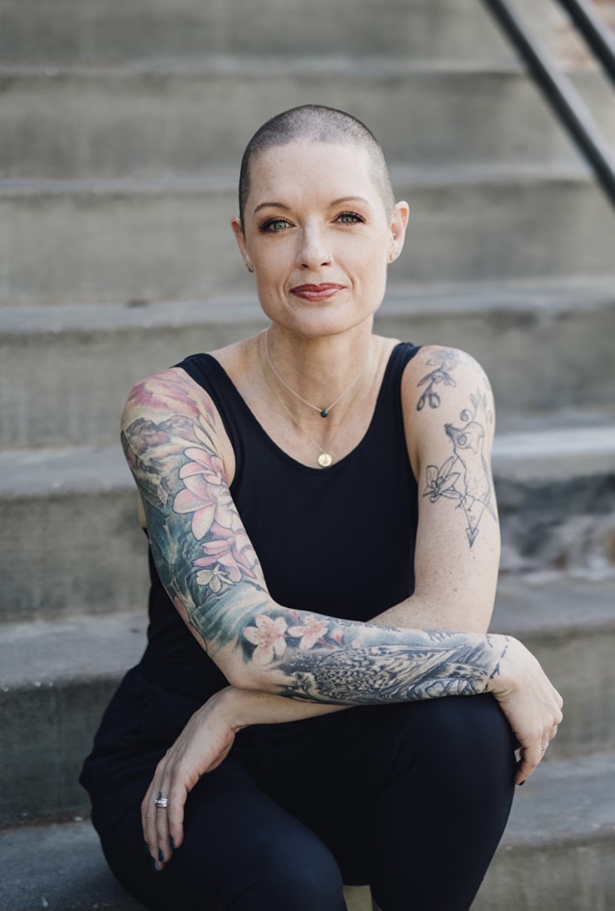 Amy Koopman is seated on stairs.