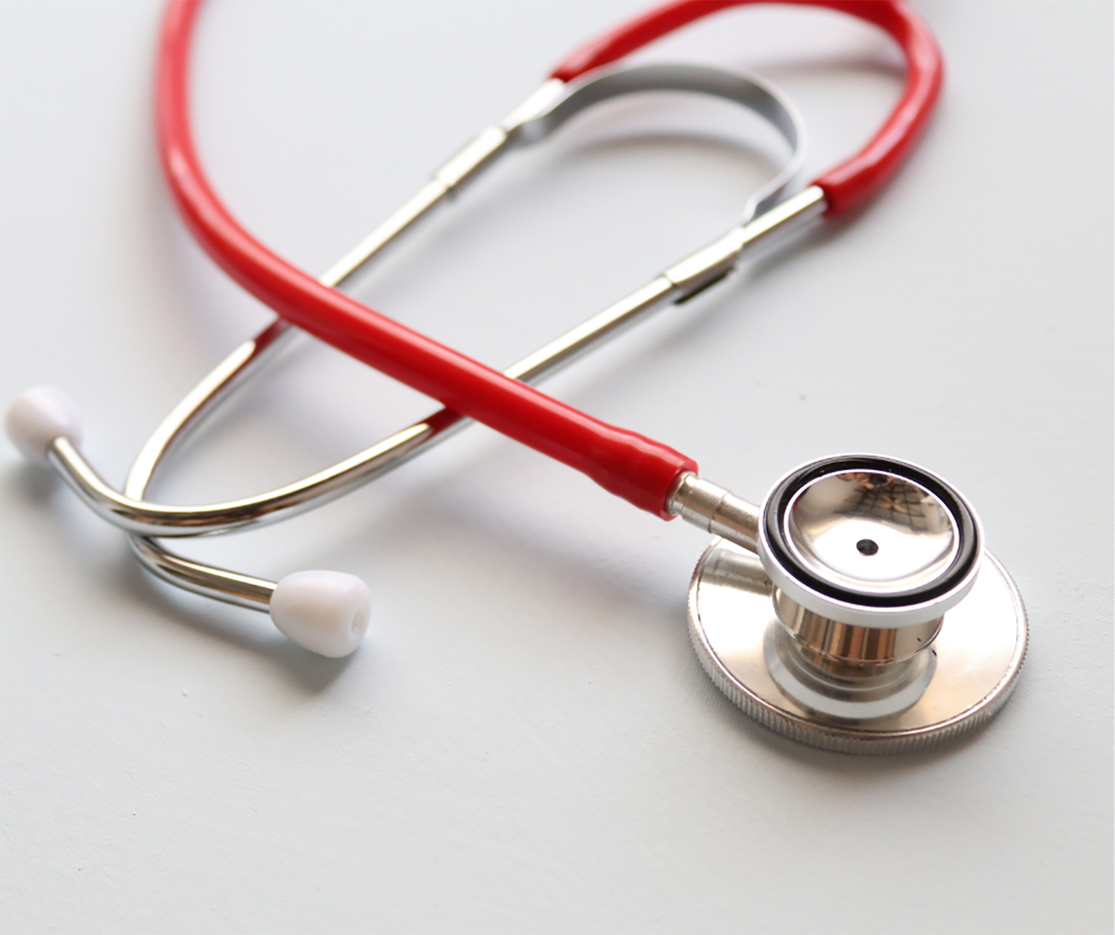Photo of a red stethoscope on a white surface