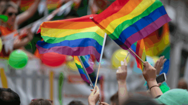 Photo of people waving Pride flags