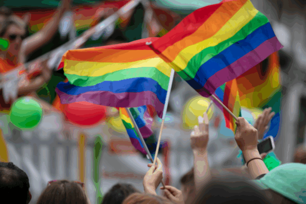 Photo of people waving Pride flags