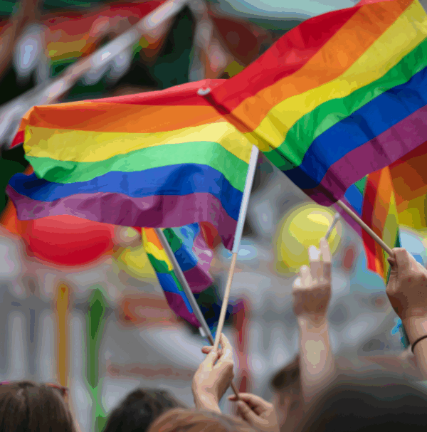 Photo of people waving Pride flags