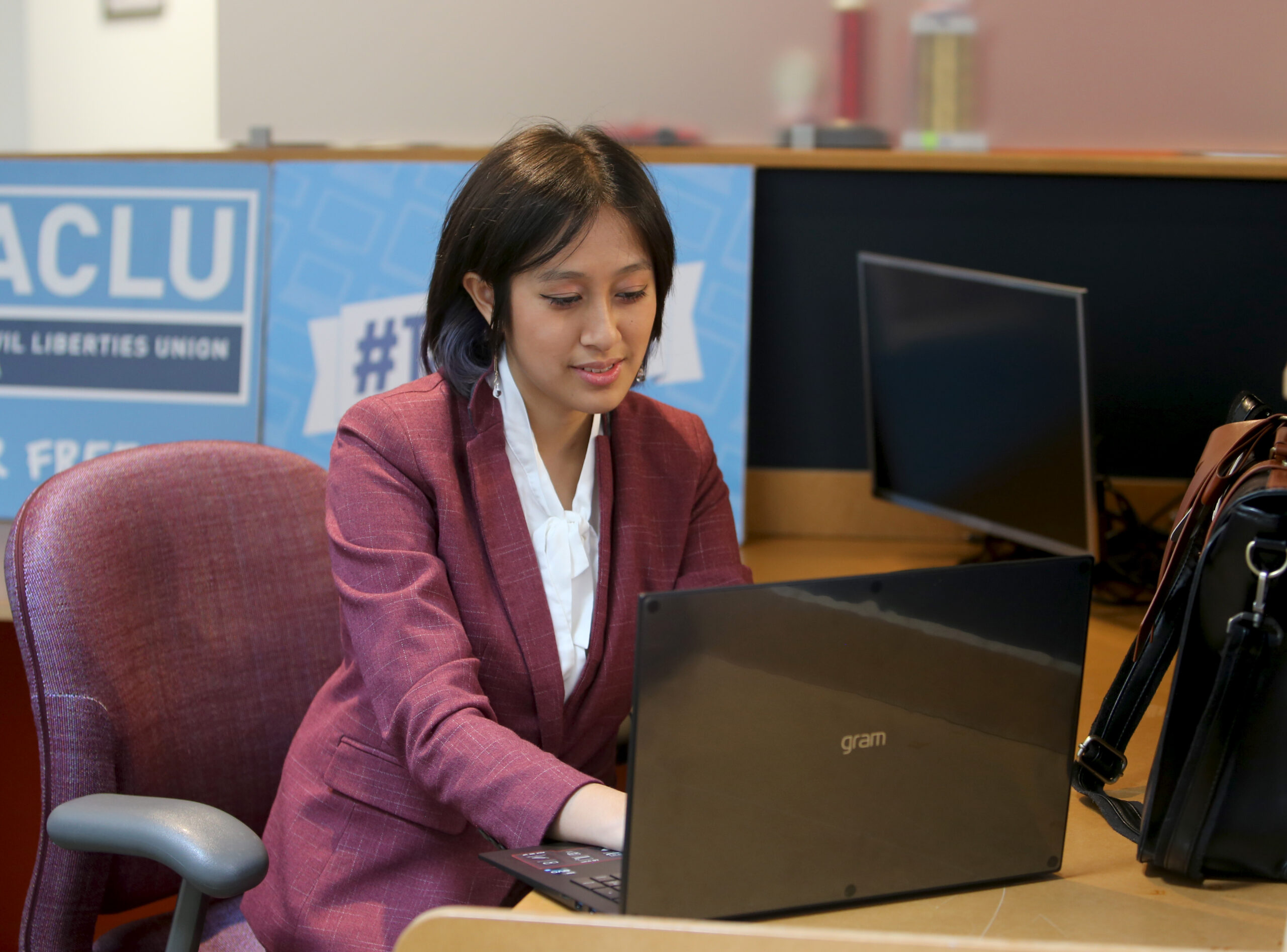 Photo of Willow working on a computer on a desk