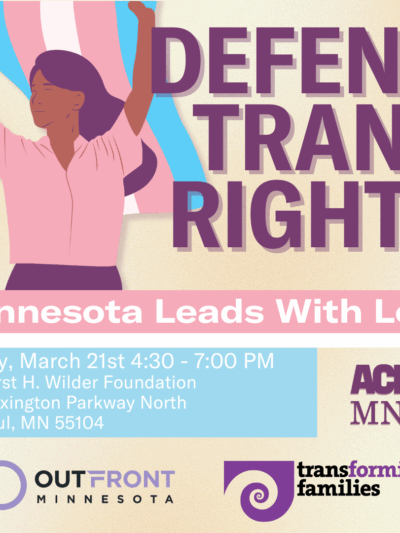 Person in pink shirt holding a flag.