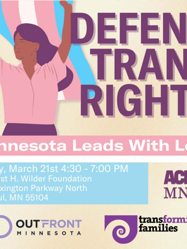 Person in pink shirt holding a flag.