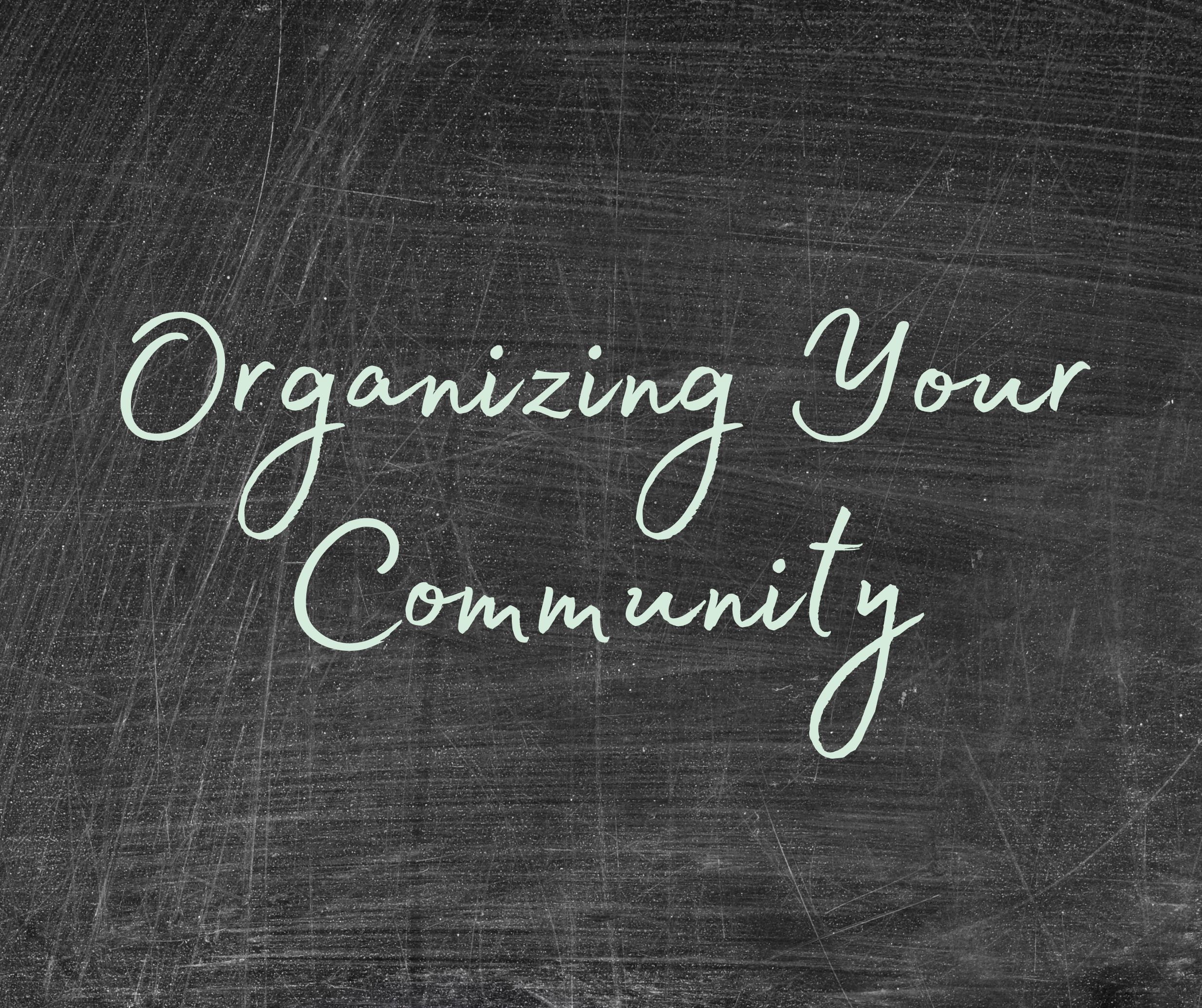 Photo of a blackboard with the words "organizing your community" written in green chalk.