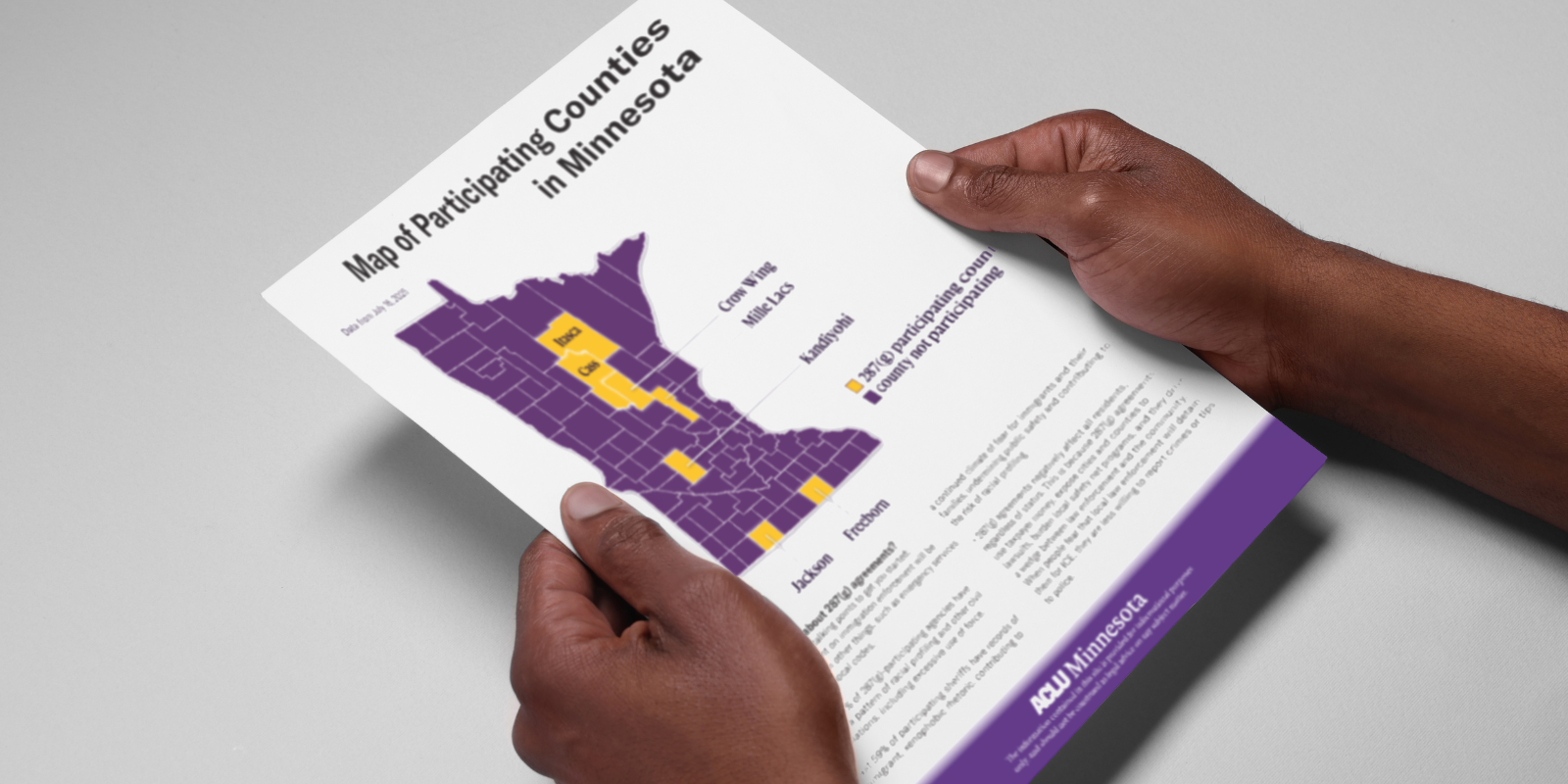 Someone holds a copy of the ACLU of Minnesota's 287(g) toolkit.