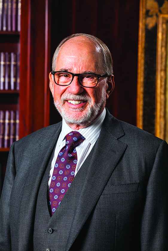 Vance Opperman is pictured in front of a bookcase