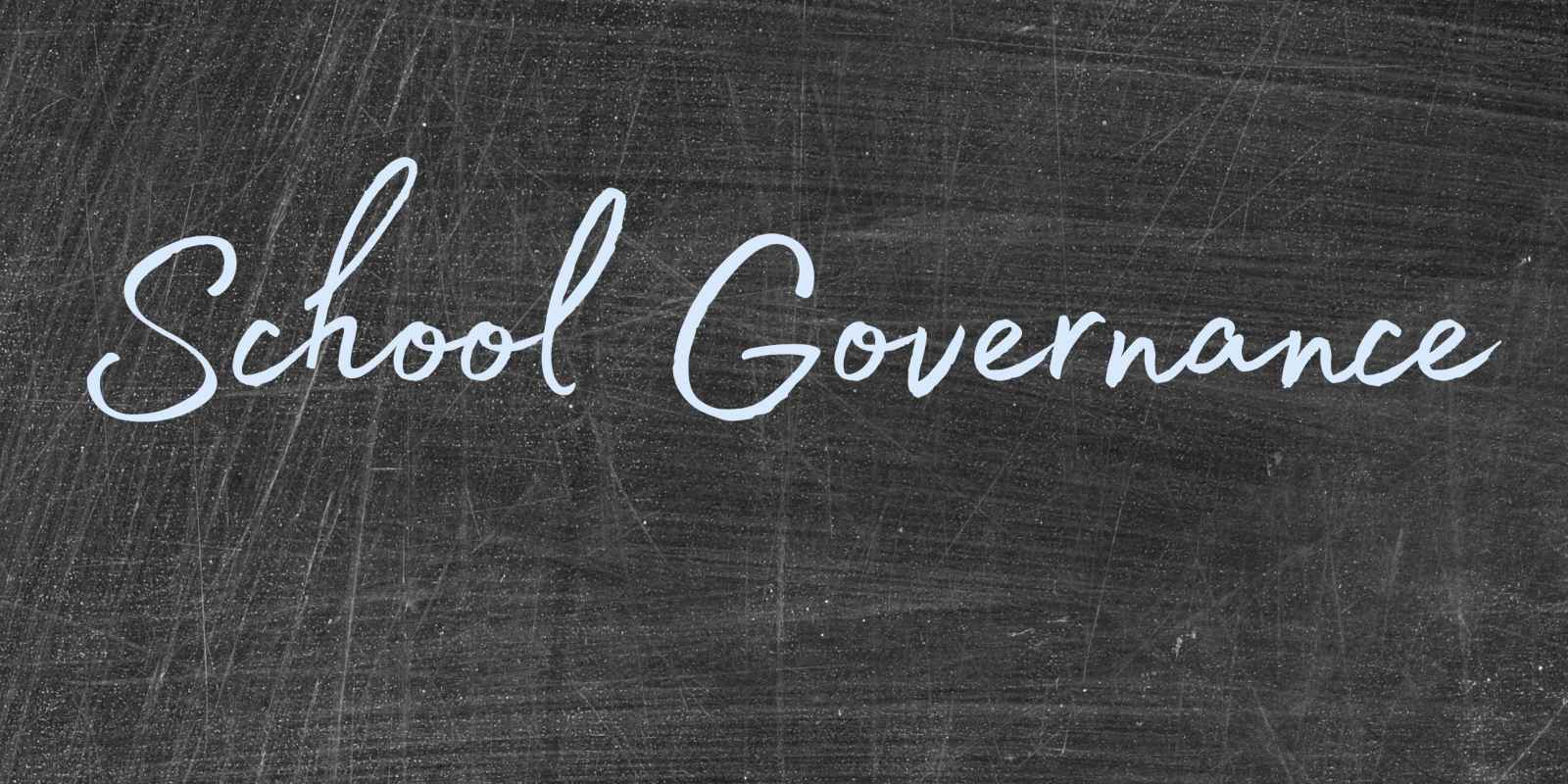 Photo of a blackboard with the words "school governance" written in blue chalk.