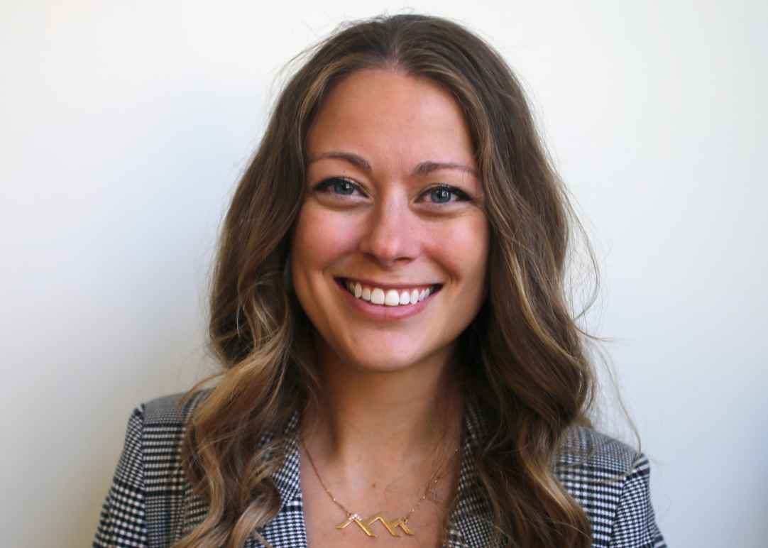 Headshot of Kelli Johnson standing against a white wall