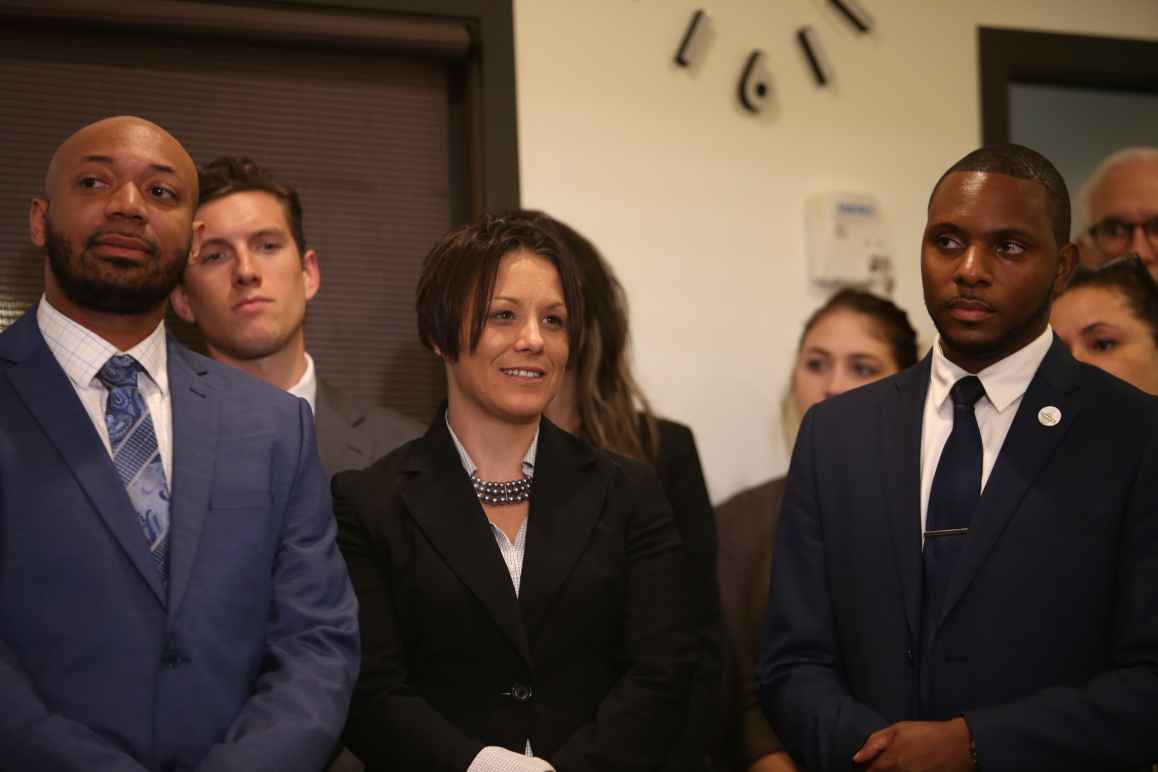 Three of our clients -- Tierre Caldwell, Jennifer Schroeder and Elizer Darris -- share a light moment while watching our Let People Vote Press Conference