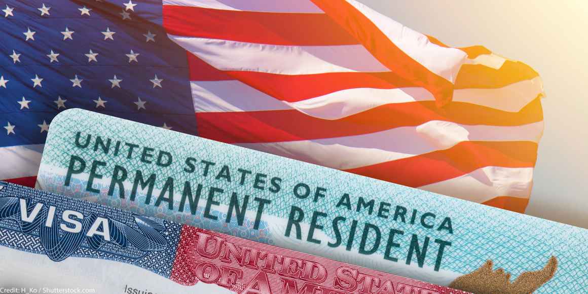 Visa and permanent resident card on top of an american flag