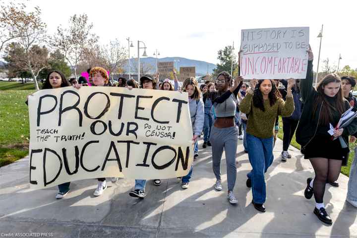 High school students march in protest of the district's ban of critical race theory curriculum at Patricia H. Birdsall Sports Park in Temecula, Calif., on Friday, Dec. 16, 2022.