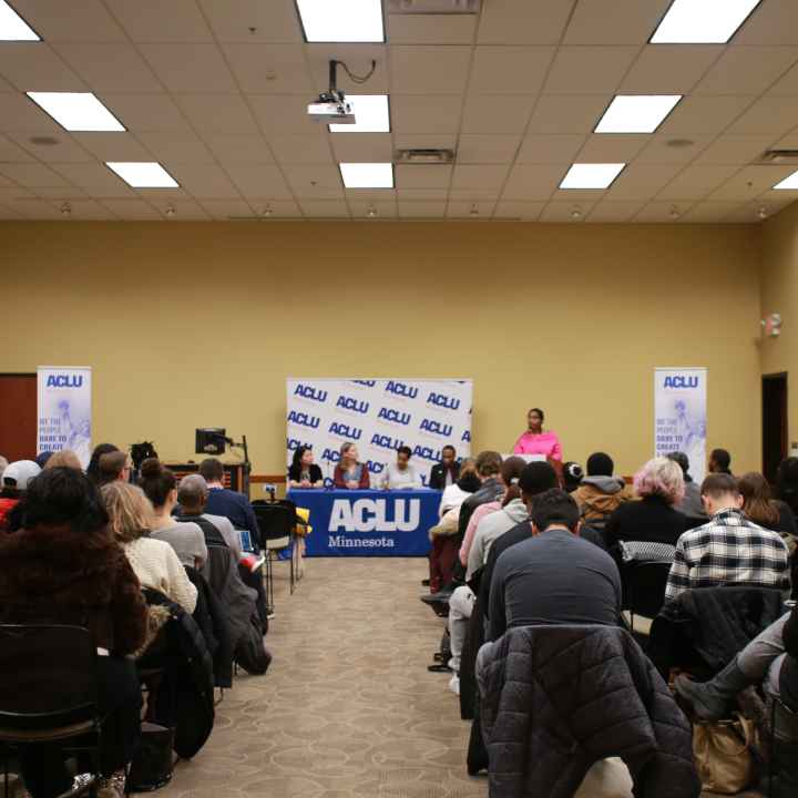 Minneapolis NAACP President Leslie Redmond speaks at a town hall event, where ACLU staff also participated. View is from the back of the room, towards the panelists' table.
