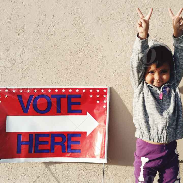 Credit: @smashleytime/ Twenty20 child next to a vote here sign