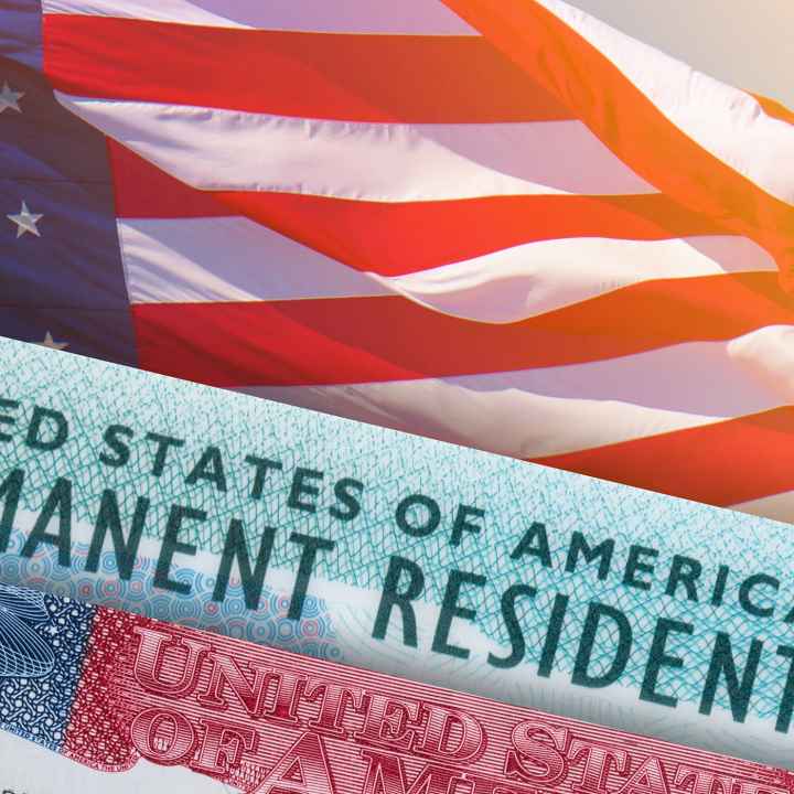 Visa and permanent resident card on top of an american flag