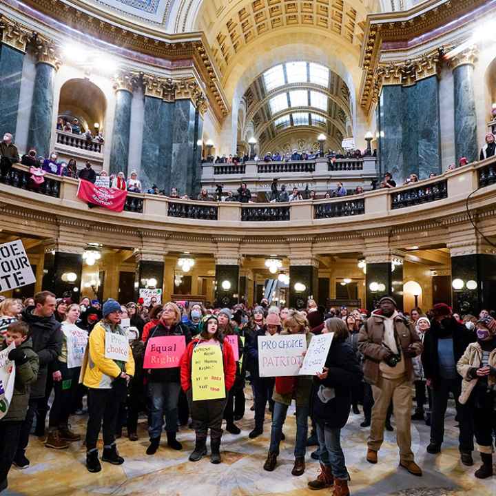 Pro-choice protesters holding signs in the Wisconsin capitol.